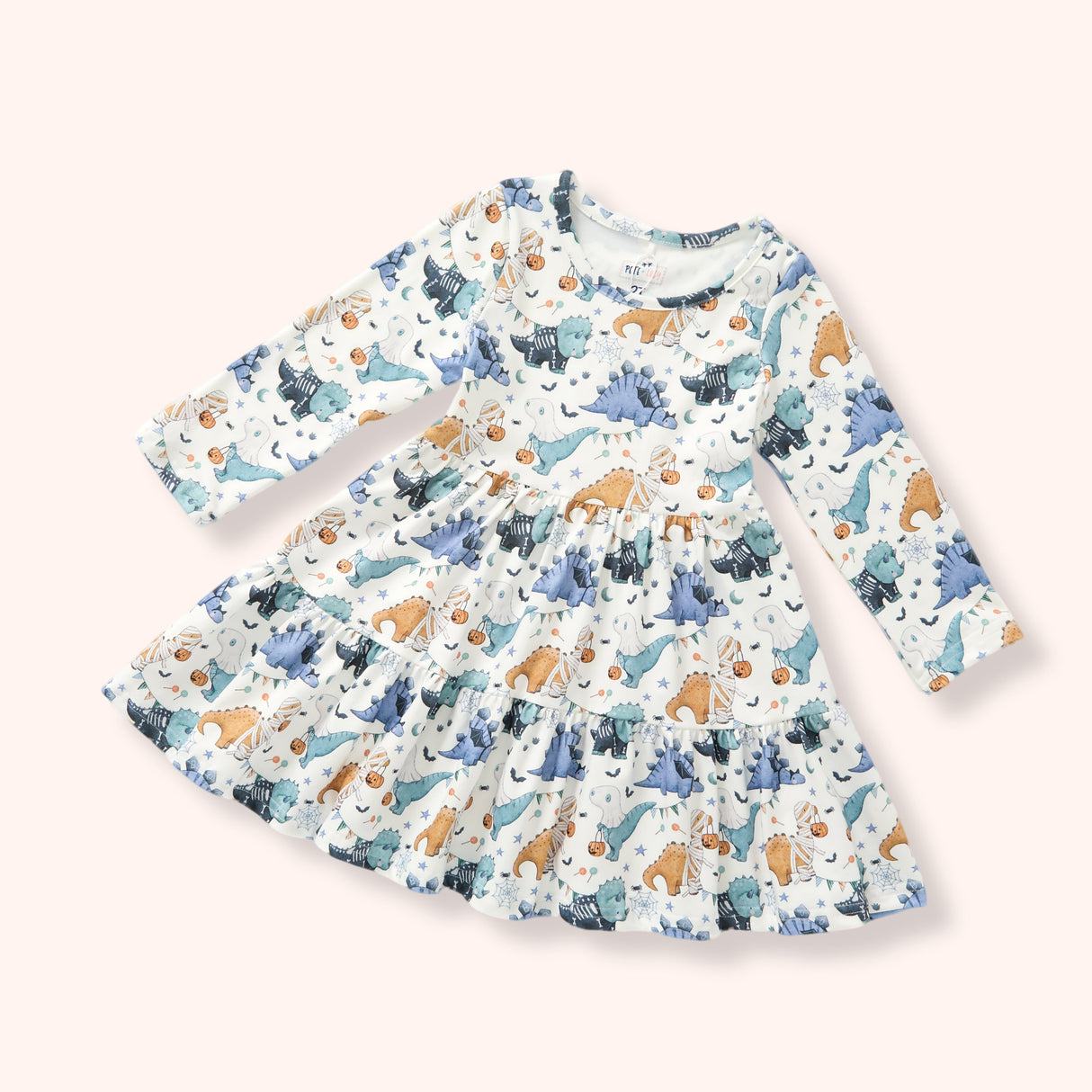 Girls cream long sleeve dress with blue and teal Halloween dinosaurs, pumpkins and a tiered skirt.