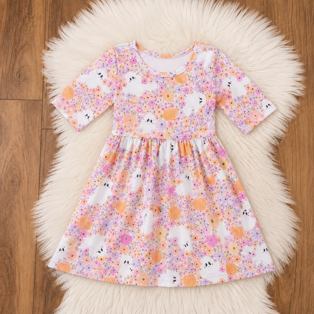 White bamboo dress with pastel flowers, orange pumpkins and tiny ghost details in pink, peach and lavender.