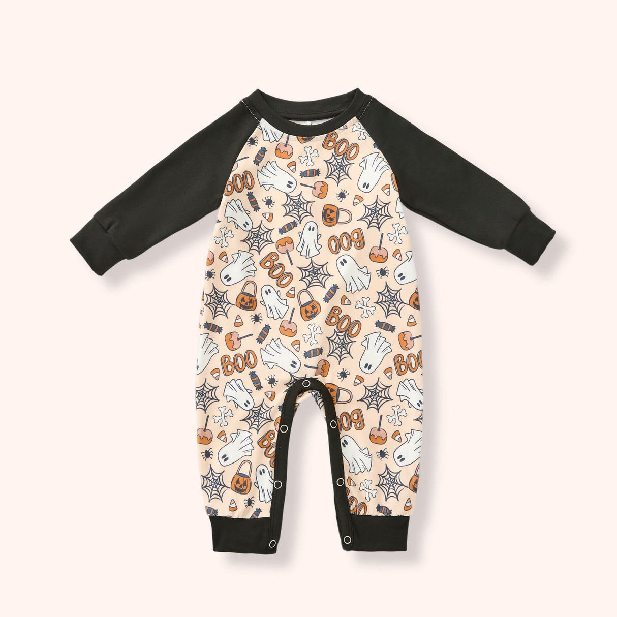 Peach baby raglan romper with black sleeves and a Halloween print of ghosts, candy, pumpkins, webs and “BOO.”