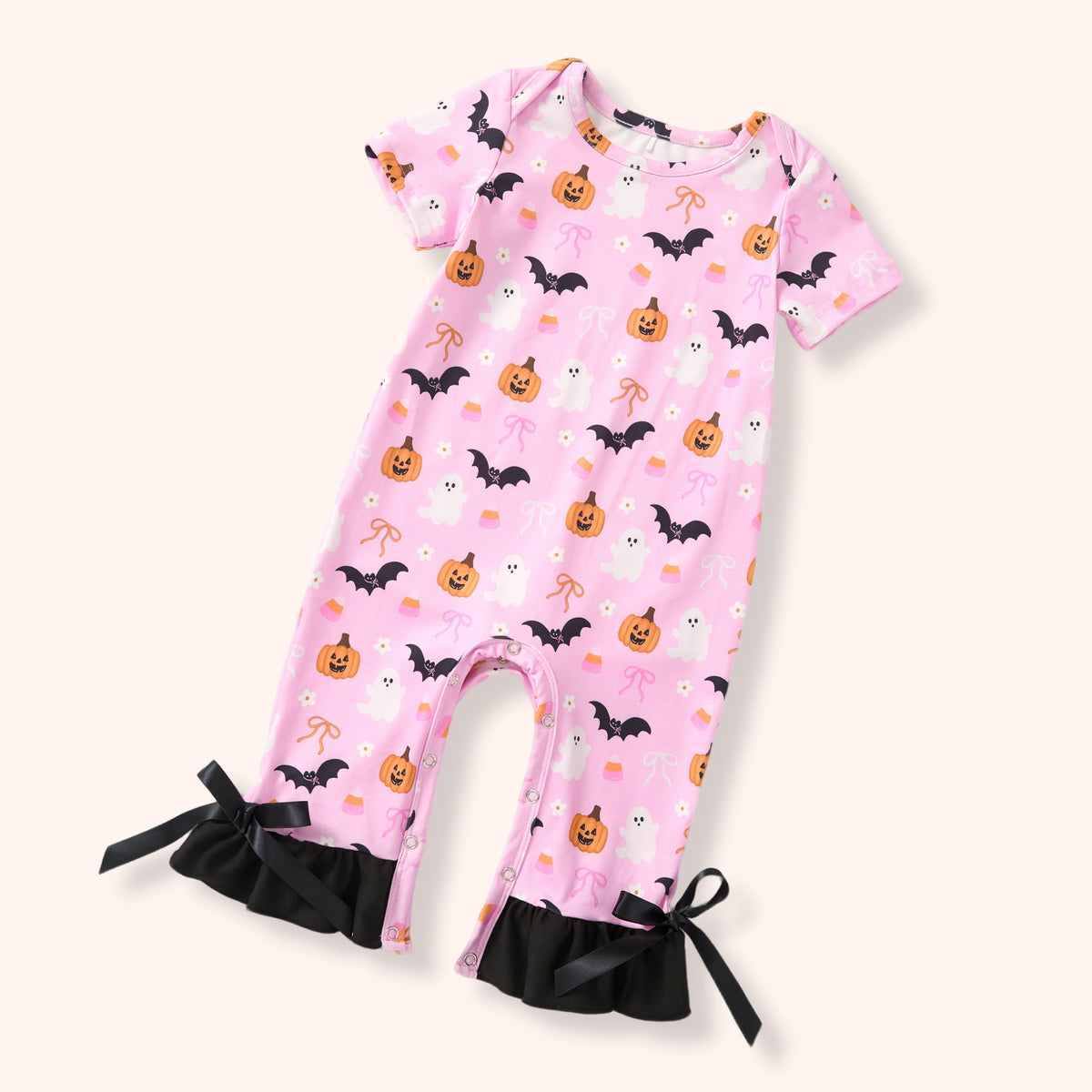 Pink Halloween-themed baby romper with pumpkins, bats, and ghosts on a white background.