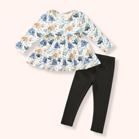 Girls cream Halloween dinosaur tunic with blue, teal and orange print paired with solid black leggings.