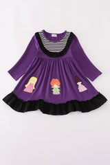 Purple dress with striped neckline, black ruffle trim, and appliqué of three witches across the hem.