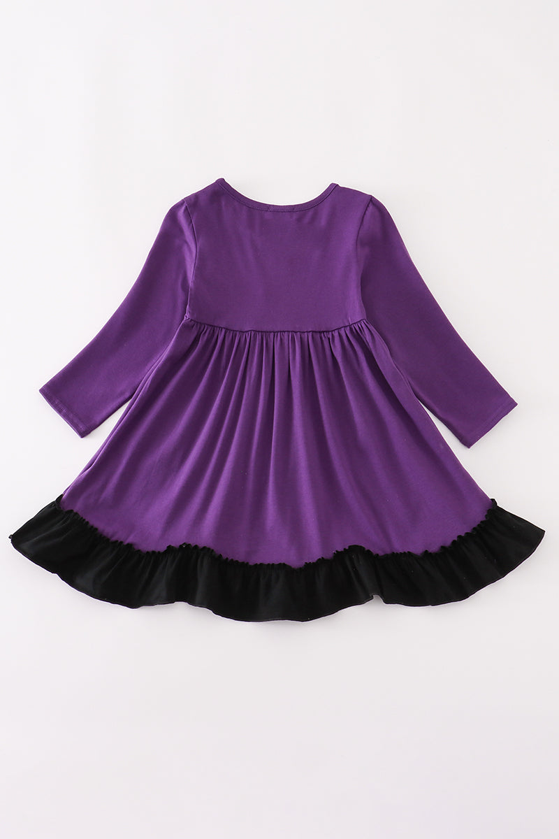 Back of purple long-sleeve dress with black ruffle hem, shown without appliqué detail.