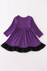 Back of purple long-sleeve dress with black ruffle hem, shown without appliqué detail.
