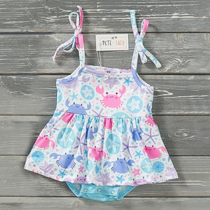 In the Tidepool Baby Romper by Pete and Lucy