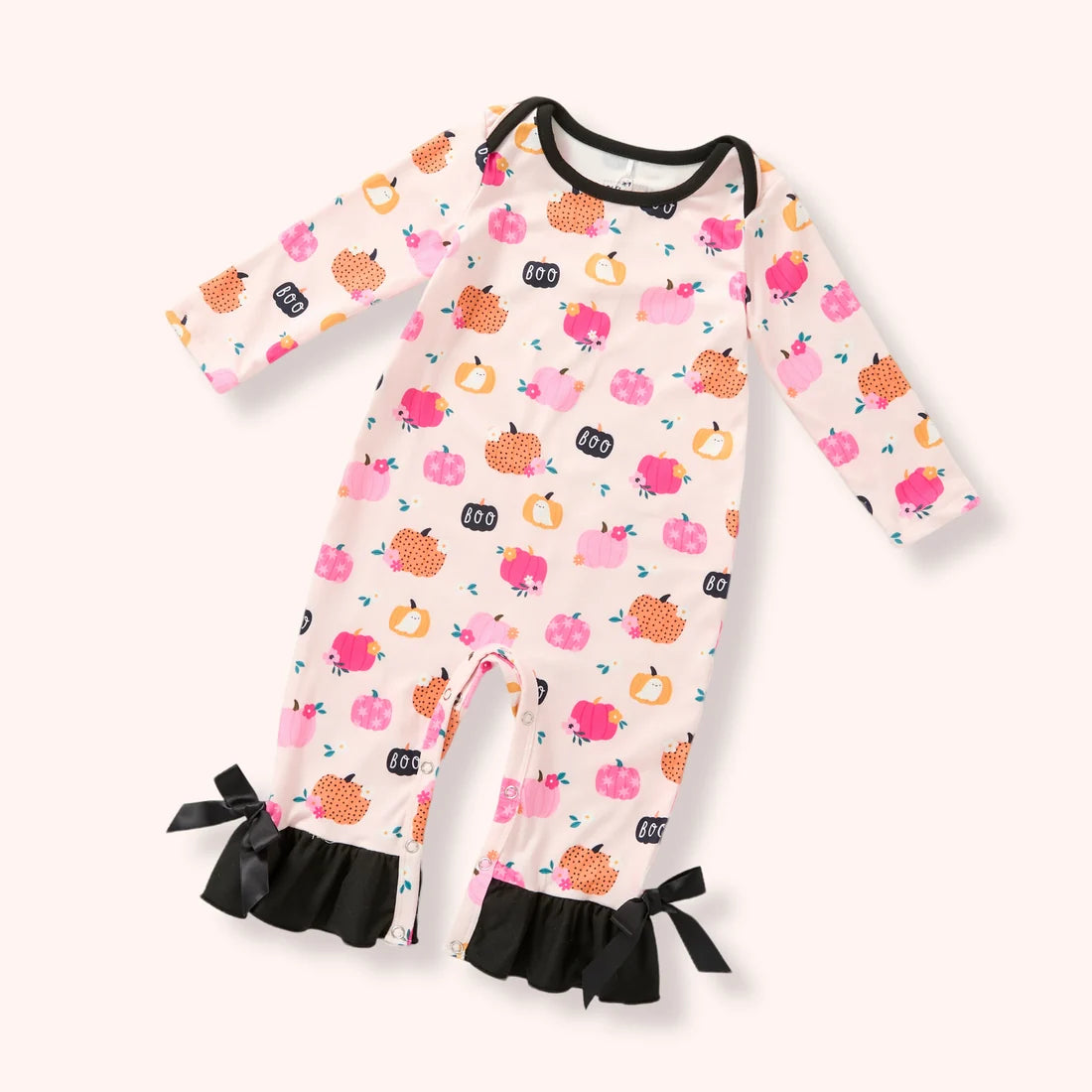 Baby cream pumpkin and “BOO” print romper with black ruffle ankle cuffs and bows.