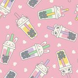 A close-up of the Pete + Lucy Bubble Tea print, featuring smiling animal faces inside colorful boba tea cups on a soft pink background scattered with white hearts.