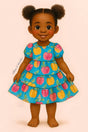 A storybook-style illustration of a smiling young girl with rich brown skin and puffy pigtails, standing sweetly against a soft pink background. She wears a short-sleeve tiered dress with a vibrant blue background and a colorful pattern of painted apples in yellow, pink, and red. Her natural stance and bright expression capture a playful, storybook feel.