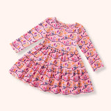 Pink long sleeve tiered dress with colorful owl, branch and autumn leaf print.
