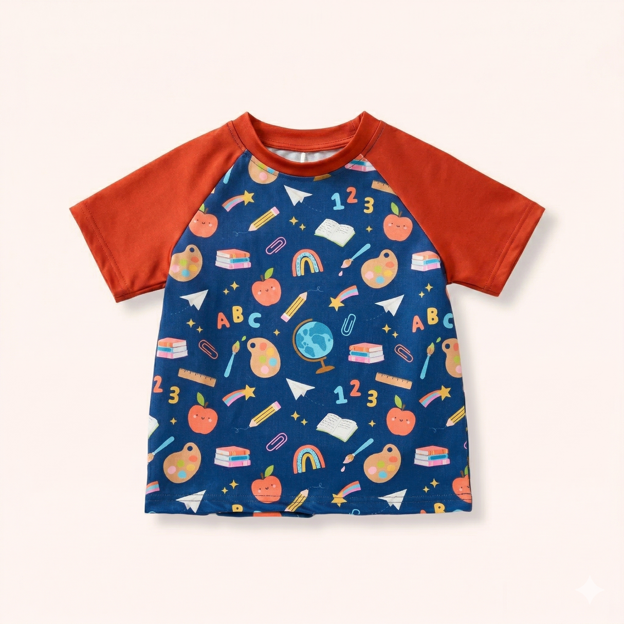 Navy and rust raglan T-shirt with colorful apples, books, pencils, art palettes, numbers, letters and rainbows.