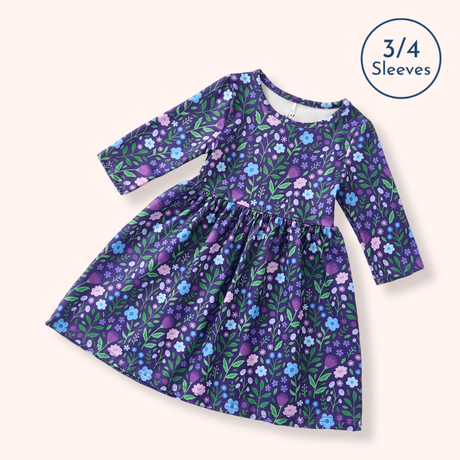 Flat lay of the Breezy Blossoms purple floral dress with a round neckline, three-quarter sleeves, gathered waist, and full skirt.