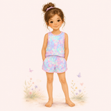 Illustrated girl wearing a pastel pink, lavender, aqua and mint sleeveless loungewear set with matching shorts.