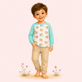 Illustrated boy wearing a mint raglan top with whimsical woodland critters in a soft storybook meadow scene.