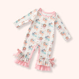 Pastel woodland long-sleeve romper with pink trim, inner-leg snaps, layered ruffle cuffs, side bows, and soft animal print.