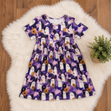 Purple bamboo dress flat lay on white faux fur over wood floor, with white ghosts and purple flowers.