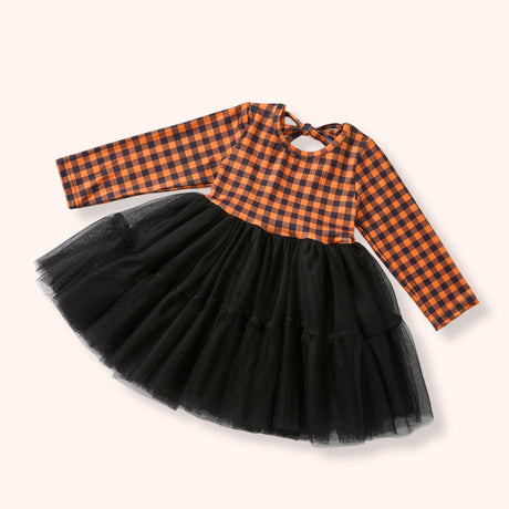 Children's dress with orange checkered top and black tulle skirt on a white background