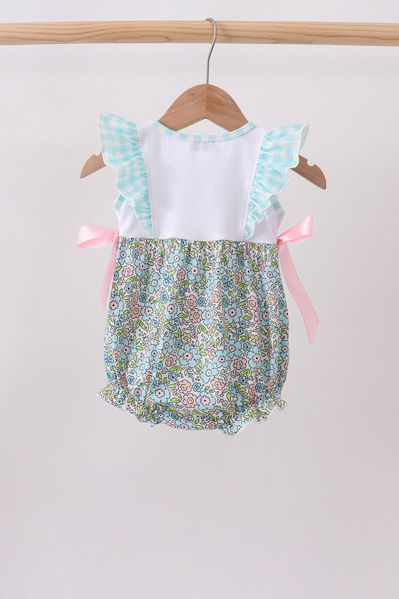 Back of the Peep + Petals baby bubble with aqua gingham ruffle straps, pastel floral bubble bottom, and pink side tie bows.