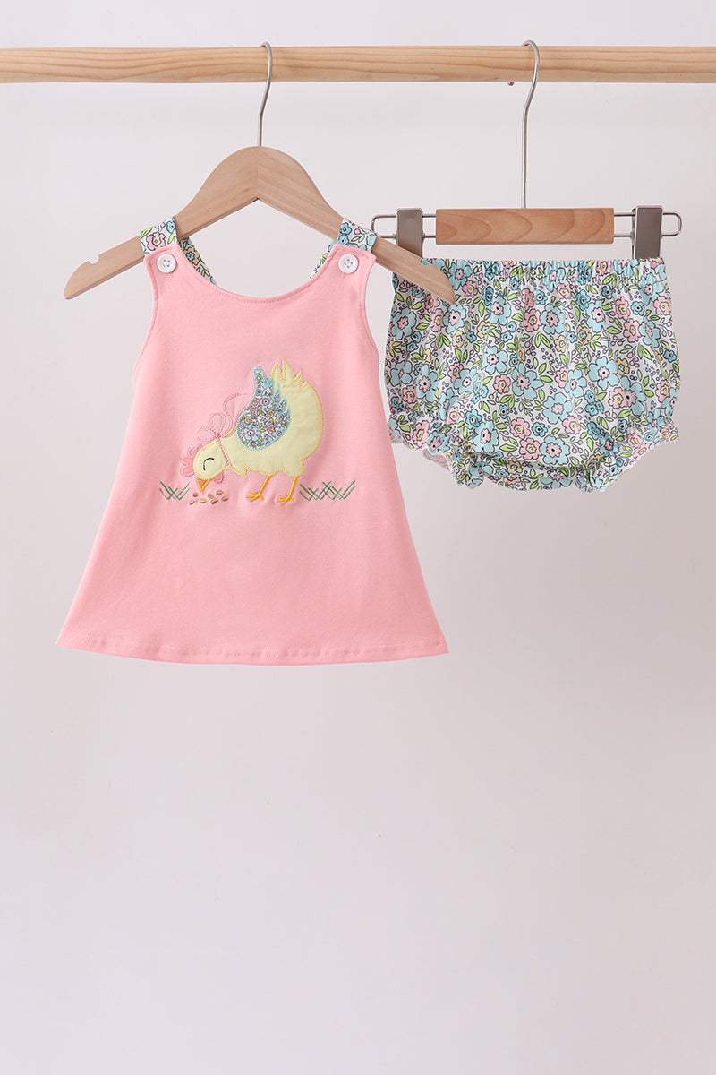 Baby girls’ pink chick bloomer set with a sleeveless appliqué tunic, floral shoulder straps, and matching floral ruffle bloomers.
