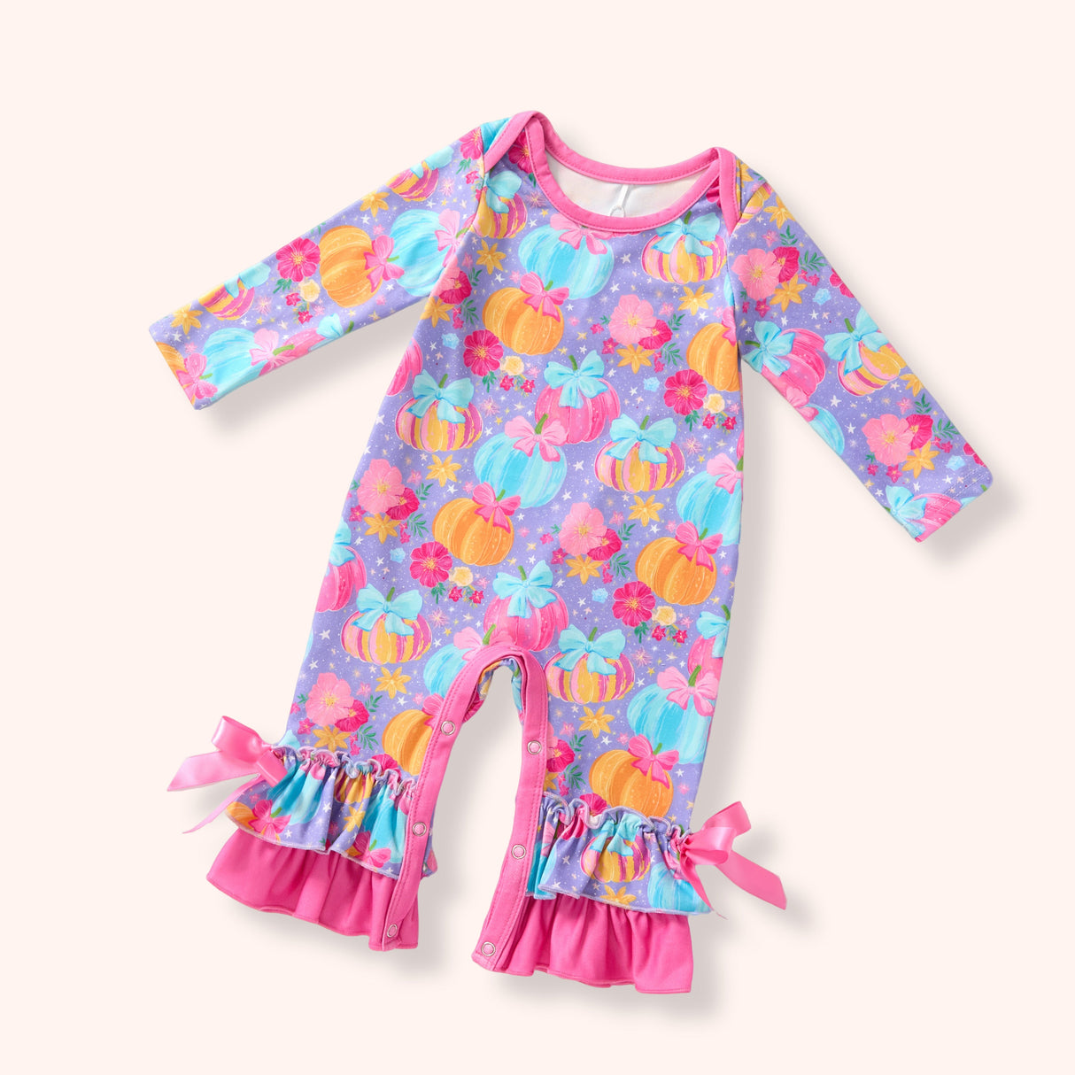 Lavender pastel pumpkin romper with pink bows, ruffle cuffs and snap closures.