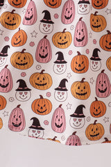 Close-up of orange pumpkins, pink acorns and black witch hats on a white background.