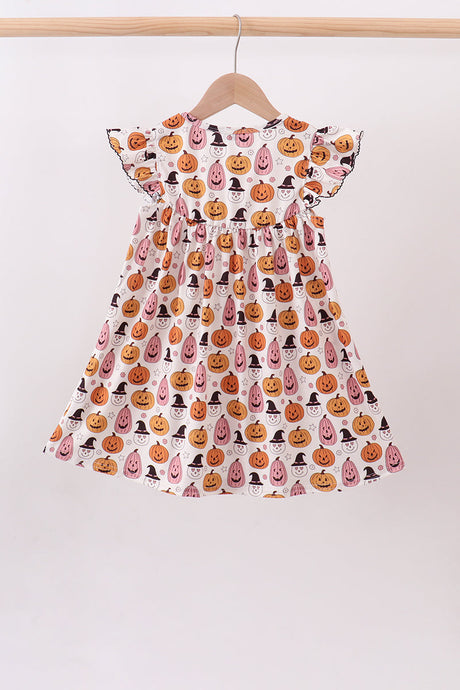 Back view of girls’ ruffle-shoulder dress with orange pumpkins, pink acorns and black witch hats on white.