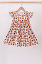 Girls’ cream twirl dress with pink and orange jack-o’-lanterns, little witches and flutter sleeves.