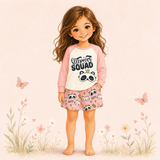 Illustrated girl wearing a pink Sleepover Squad pajama set with a panda graphic top and printed shorts.