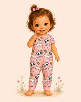 Illustrated toddler in a pink short-sleeve panda-and-kitty pajama romper, smiling barefoot among tiny pastel flowers.