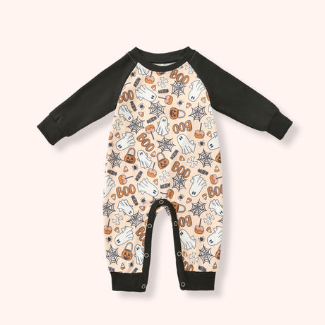 Peach baby raglan romper with black sleeves and a Halloween print of ghosts, candy, pumpkins, webs and “BOO.”