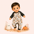 Storybook baby boy wearing a peach Halloween raglan romper with ghosts, candy, pumpkins and black sleeves.