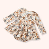 Peach skirted baby bubble with an allover Halloween print of ghosts, pumpkins, candy, webs and “BOO.”