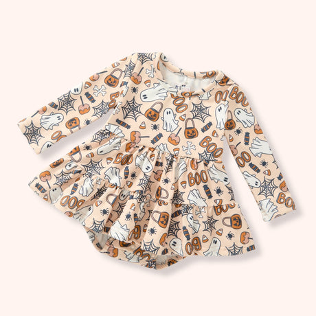 Peach skirted baby bubble with an allover Halloween print of ghosts, pumpkins, candy, webs and “BOO.”