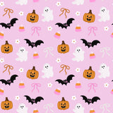 Halloween-themed pattern with pumpkins, ghosts, bats, and candy on a pink background.